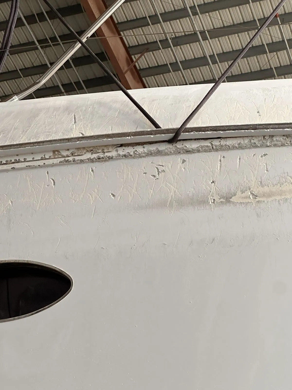 Hull side scuffing and gelcoat damage from the storm
