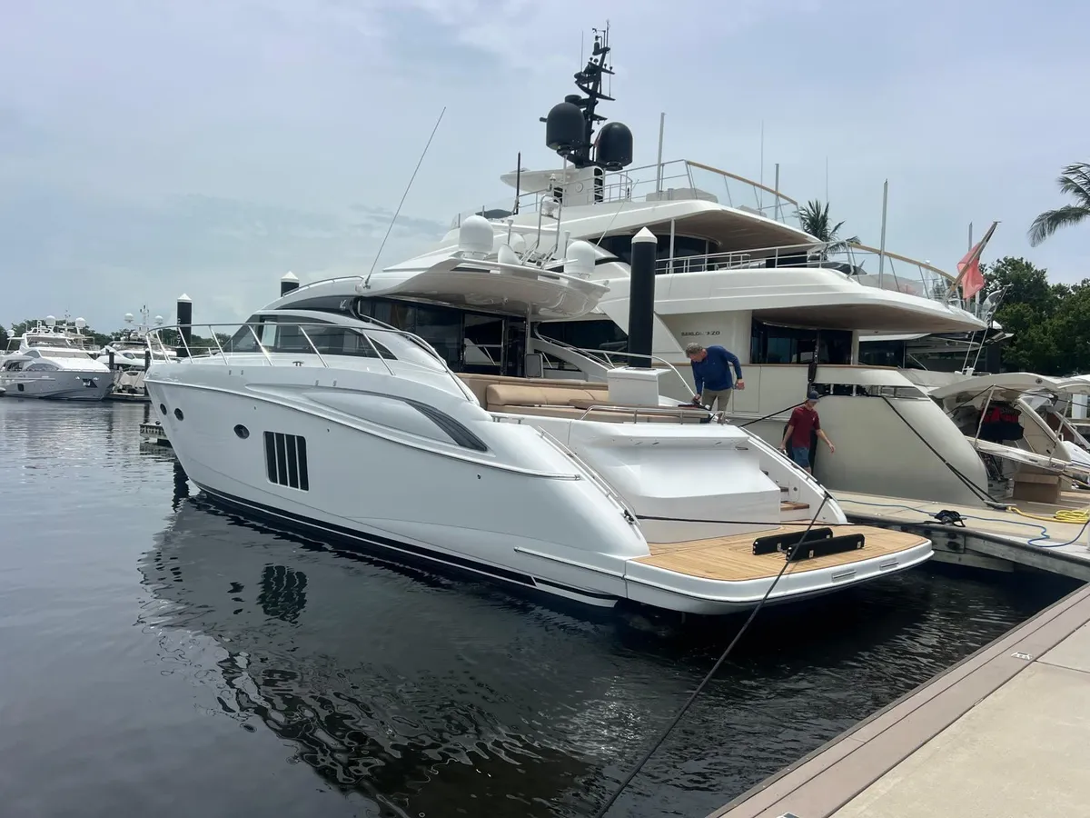 Princess V65 back in the water after restoration, new teak swim platform visible at the stern