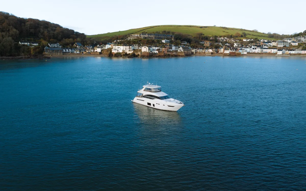 Motor yacht at anchor in a quiet bay