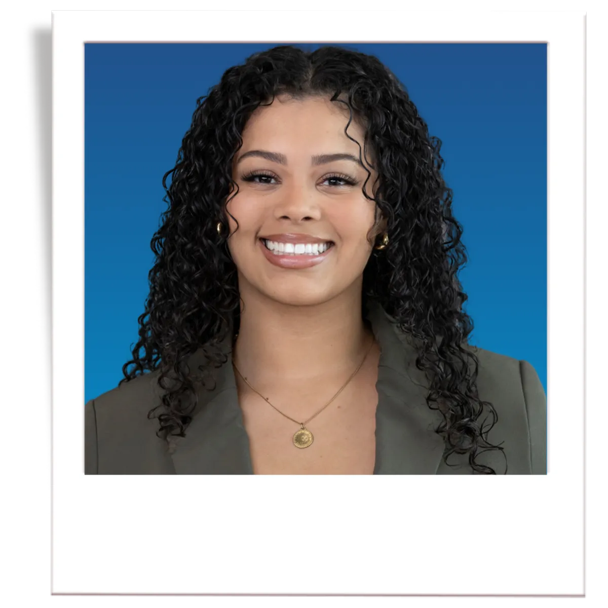 A picture of professional insurance agent, Noe Recendez. The picture is in the style of a polaroid. The insurance agent is wearing a dark grey men's blazer, a blue button down shirt, and a black tie. The agent is in front of a blue gradient background. 