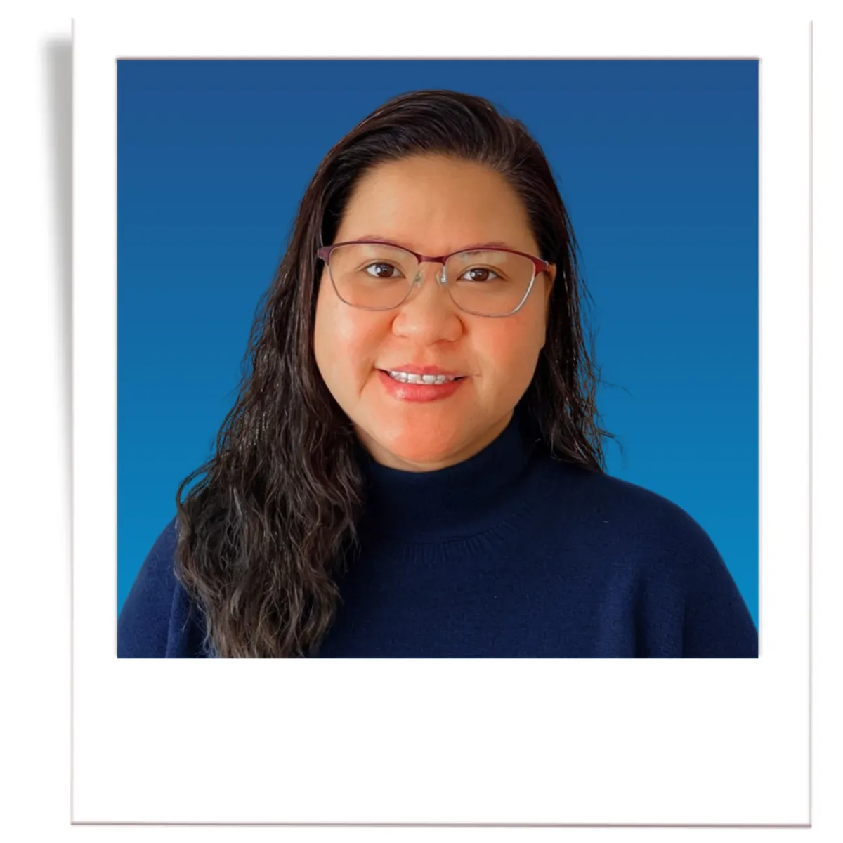 A picture of professional insurance agent, Noe Recendez. The picture is in the style of a polaroid. The insurance agent is wearing a dark grey men's blazer, a blue button down shirt, and a black tie. The agent is in front of a blue gradient background. 