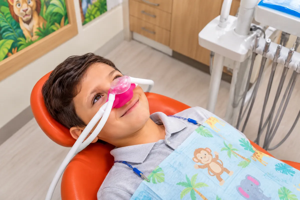 Child receiving nitrous oxide sedation at a pediatric dental office