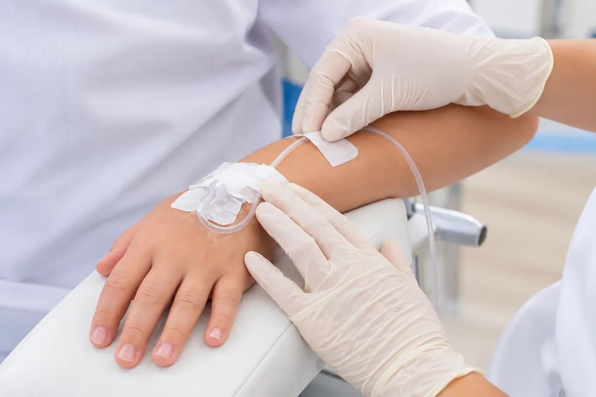 Child receiving IV sedation during pediatric dental treatment