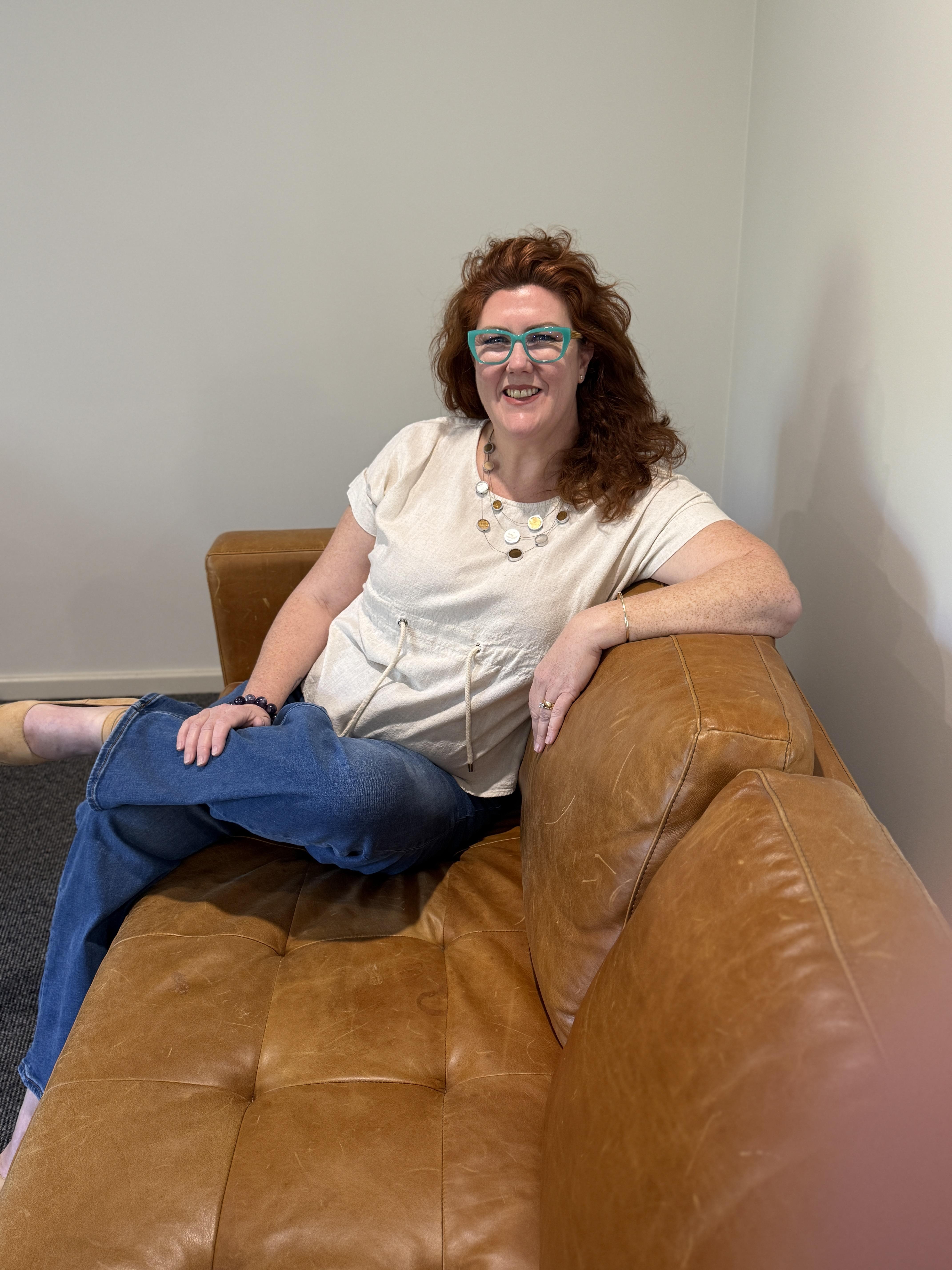 Barb sitting calmly on brown lounge