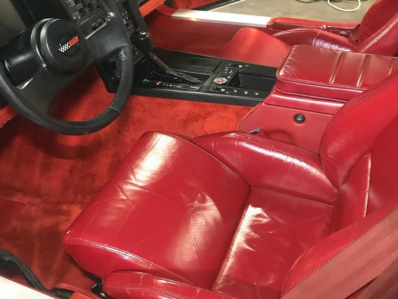 Detailer perfecting interior of executive car