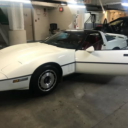 Clean sedan being detailed in a downtown Boston parking garage