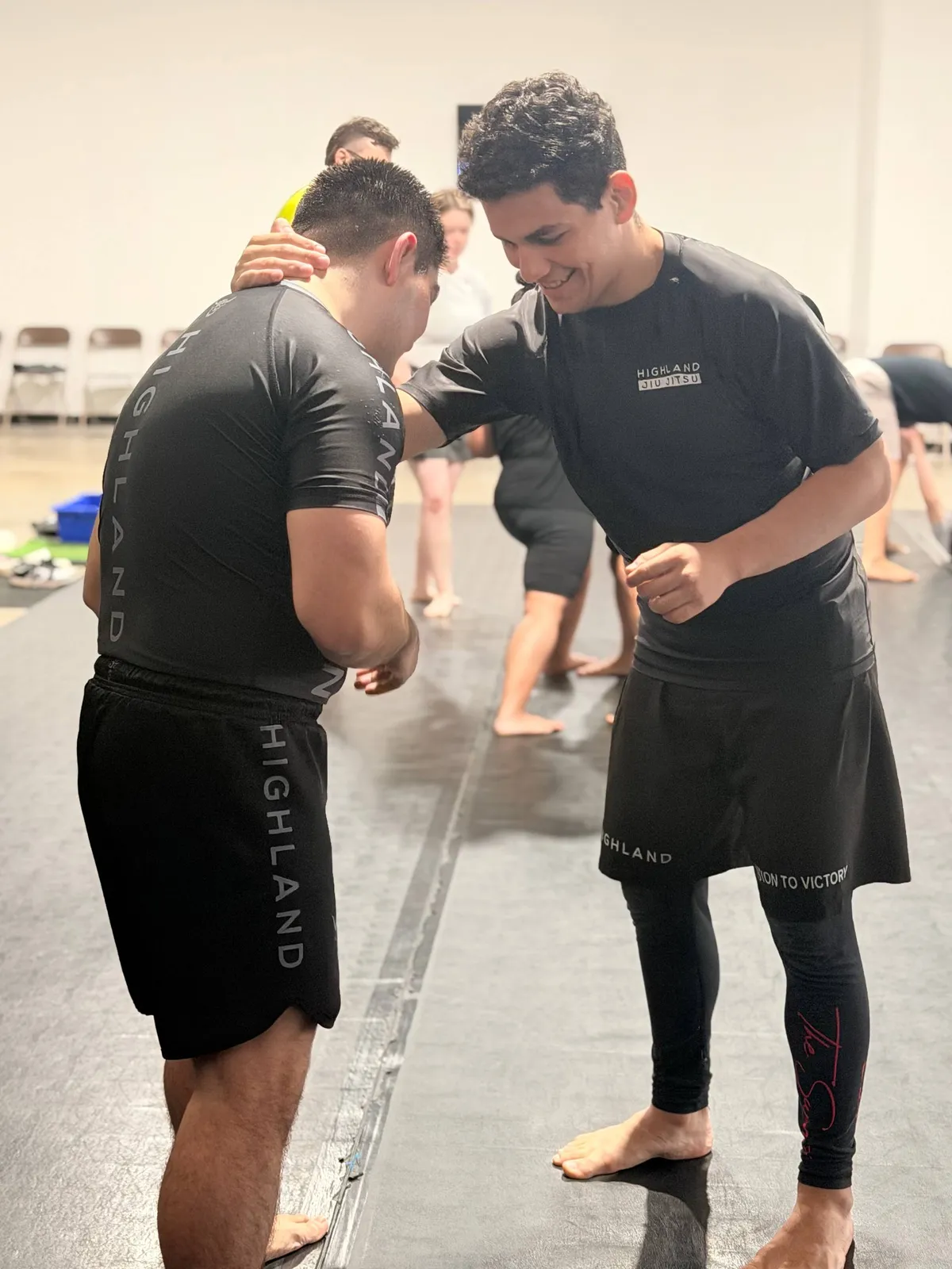 Highland Jiu Jitsu students encouraging each other during a welcoming beginner class