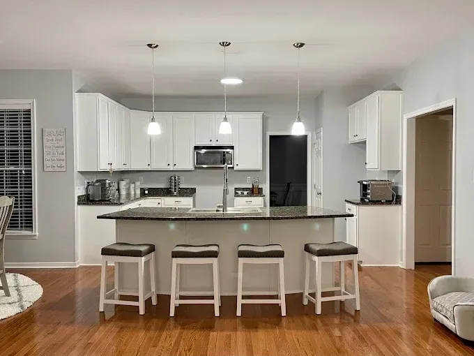 Modern Richmond living room with neutral walls, white trim, polished wood floors, and stylish furniture.