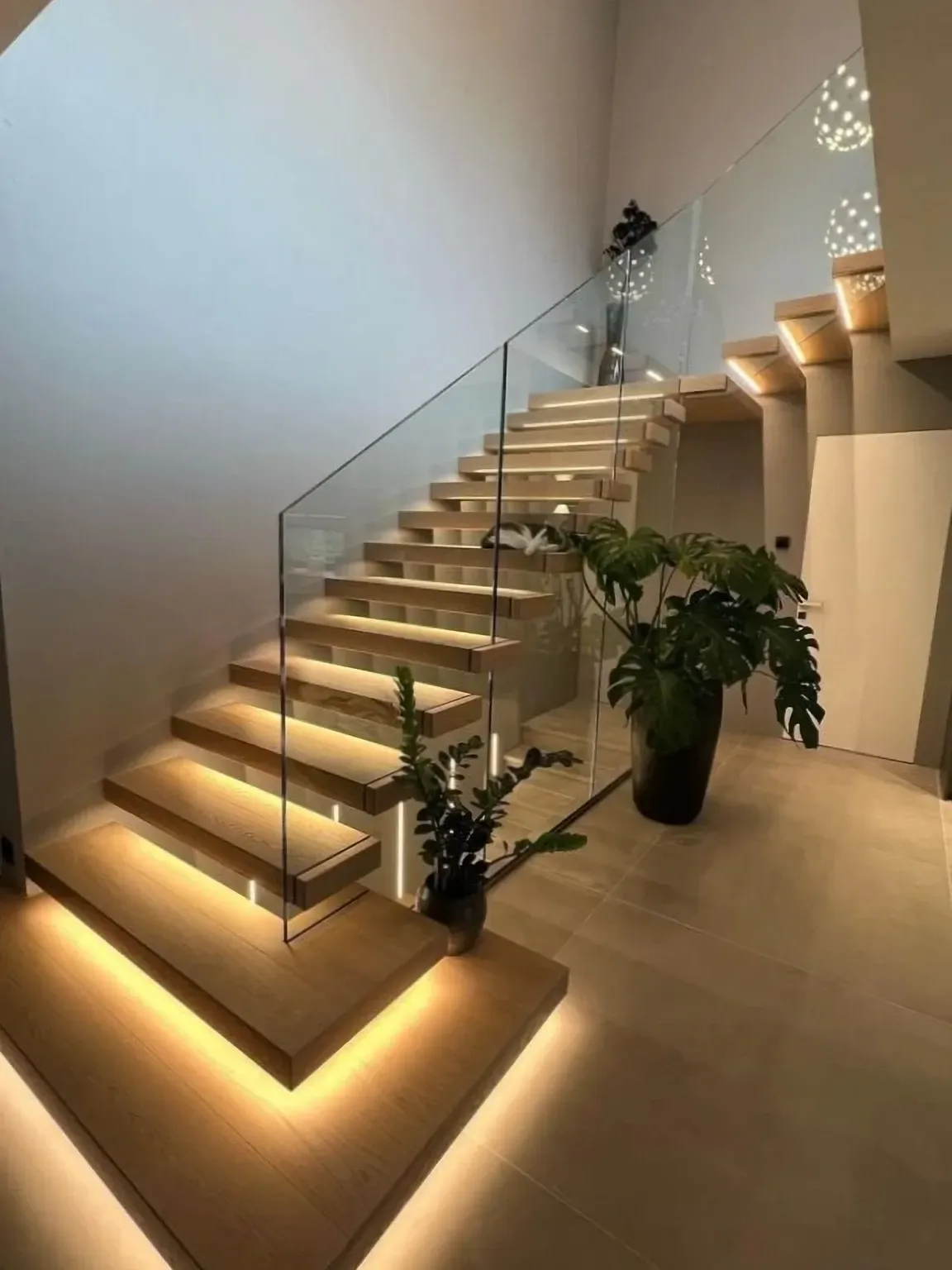 Elegant marble staircase with dark wood paneling and ornate details