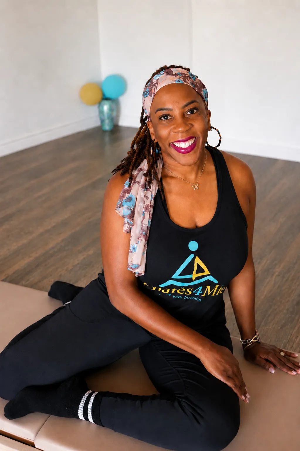 Candid studio image of Davonna actively instructing Pilates