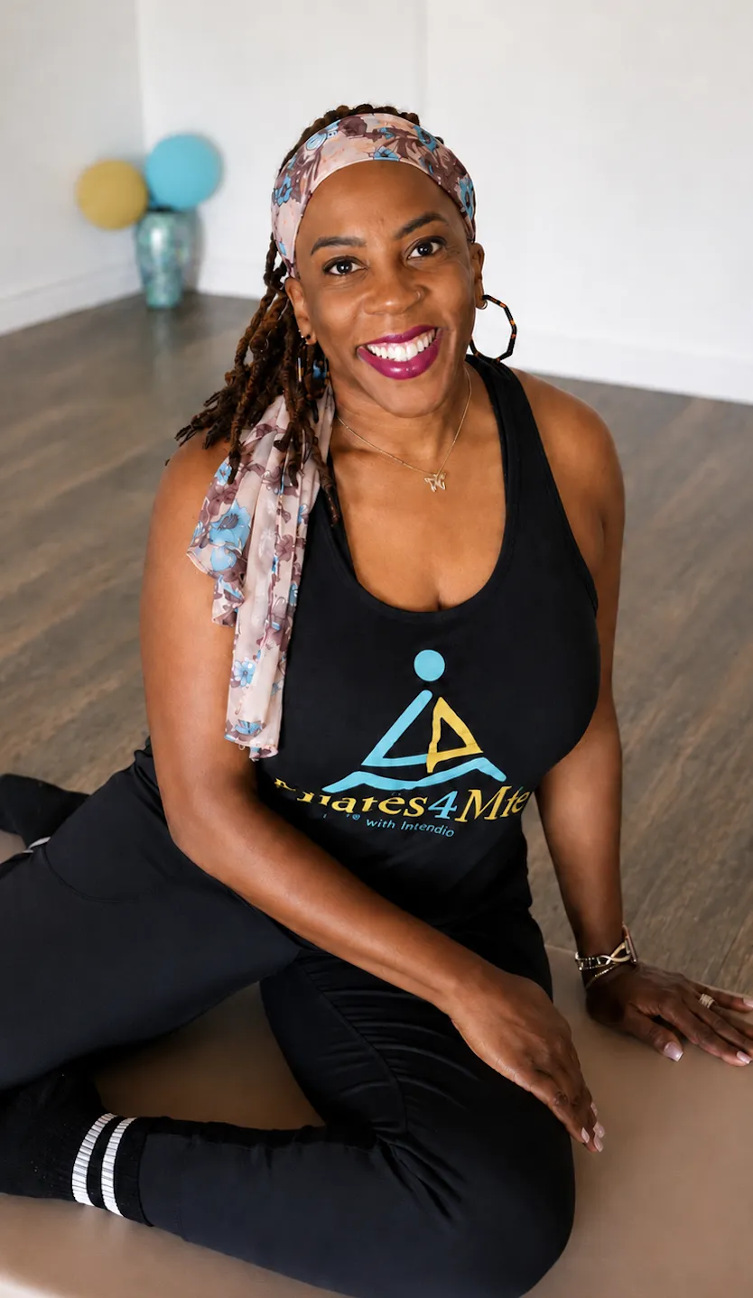Boutique Pilates Instructor stretching gracefully in natural light