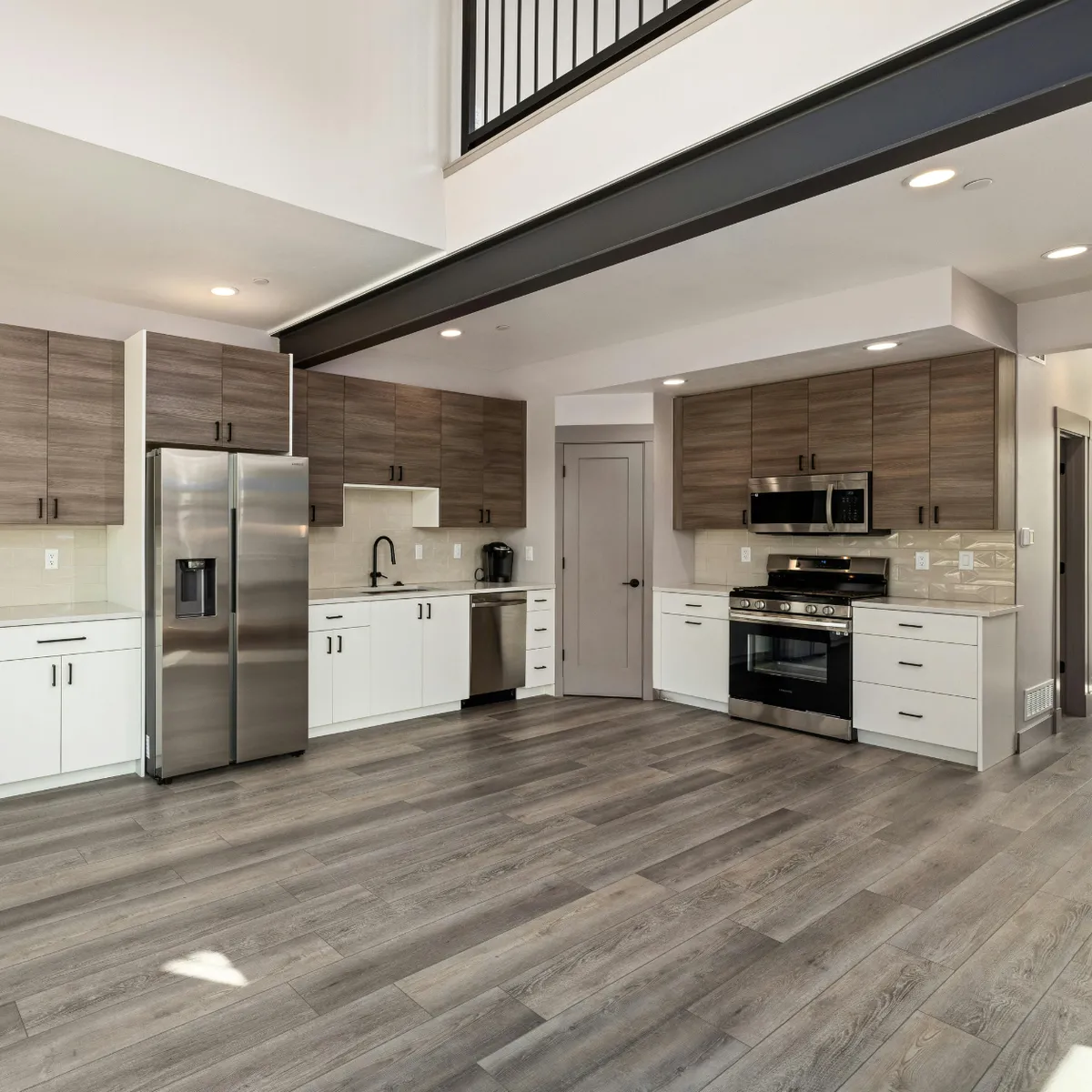 Open-concept kitchen remodeling project in the Houston area (Katy, Texas) with wood cabinetry, stainless steel appliances, and upgraded flooring.