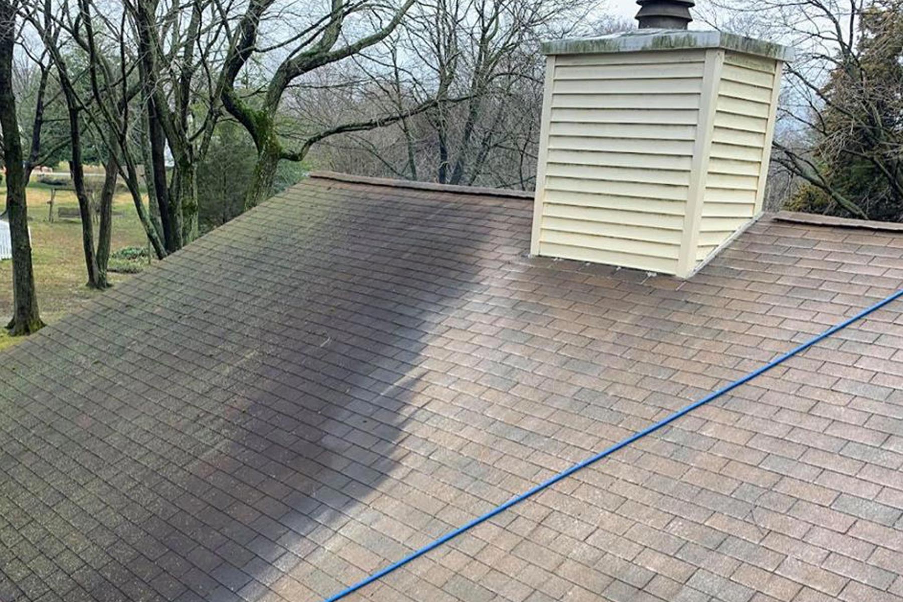 Professional pressure washing an Anderson Township home exterior