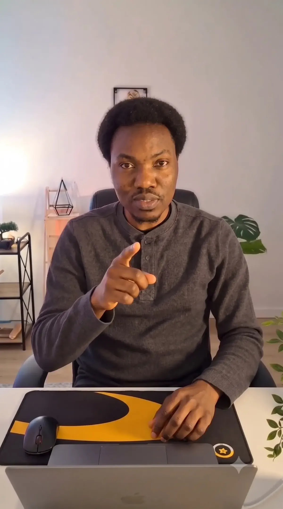 Professional headshot of Femi Dade in a modern office environment