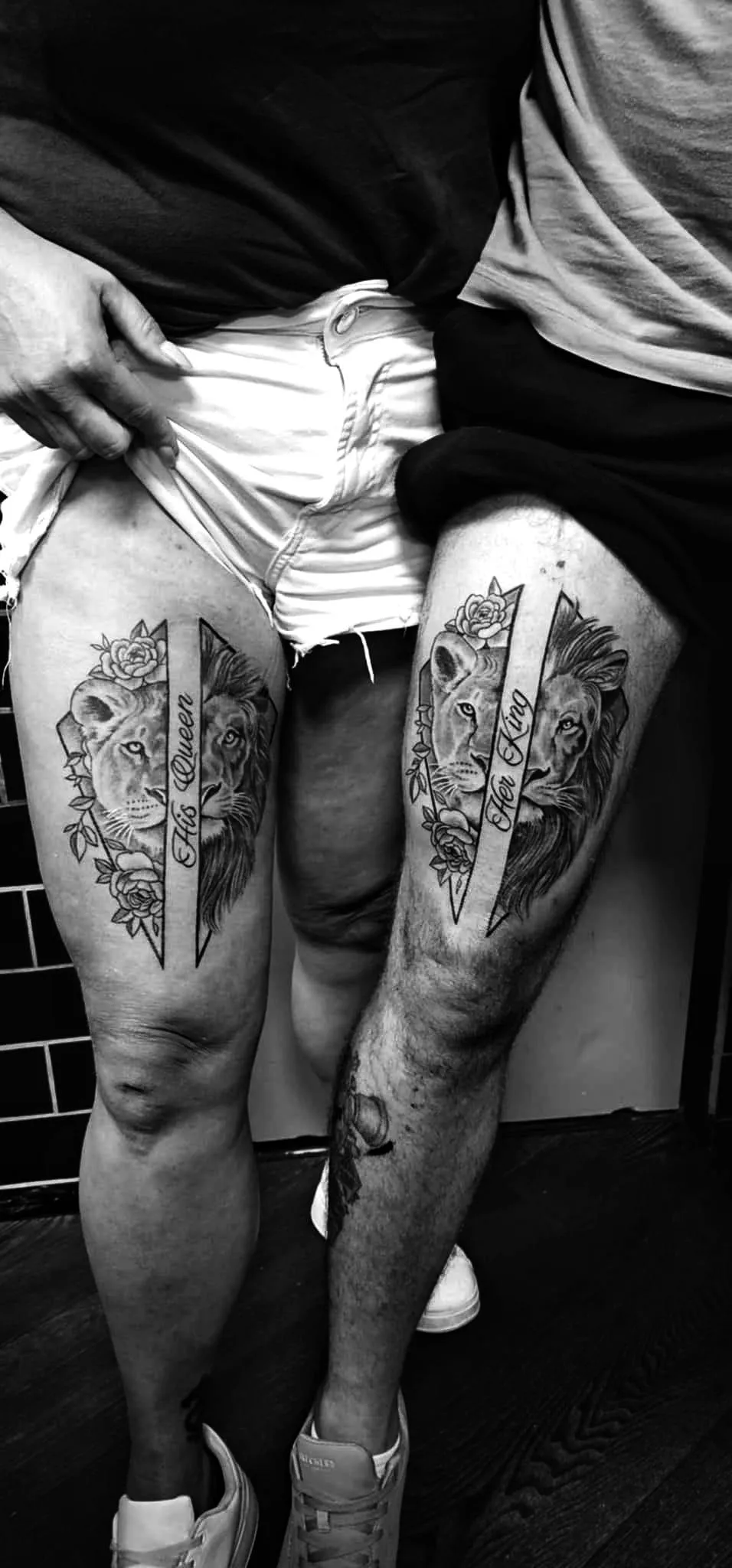 person in blue denim shorts and white nike sneakers standing on gray concrete floor