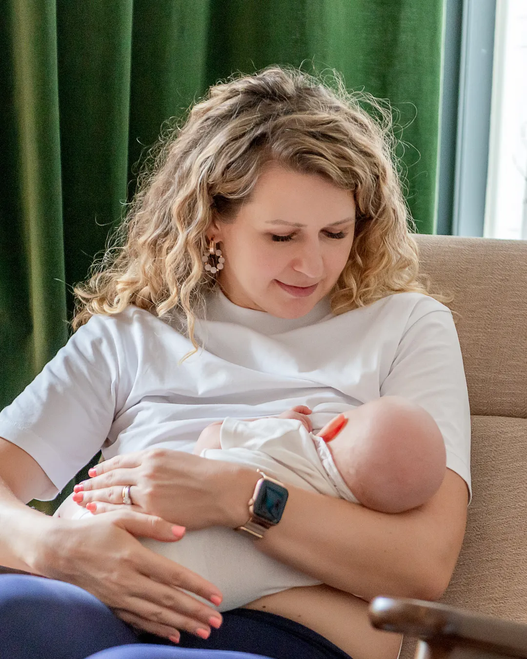 Tired but peaceful new mom resting, representing the fourth trimester