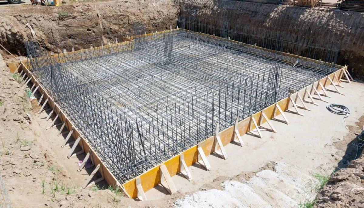 concrete foundation and slap half built with rebars