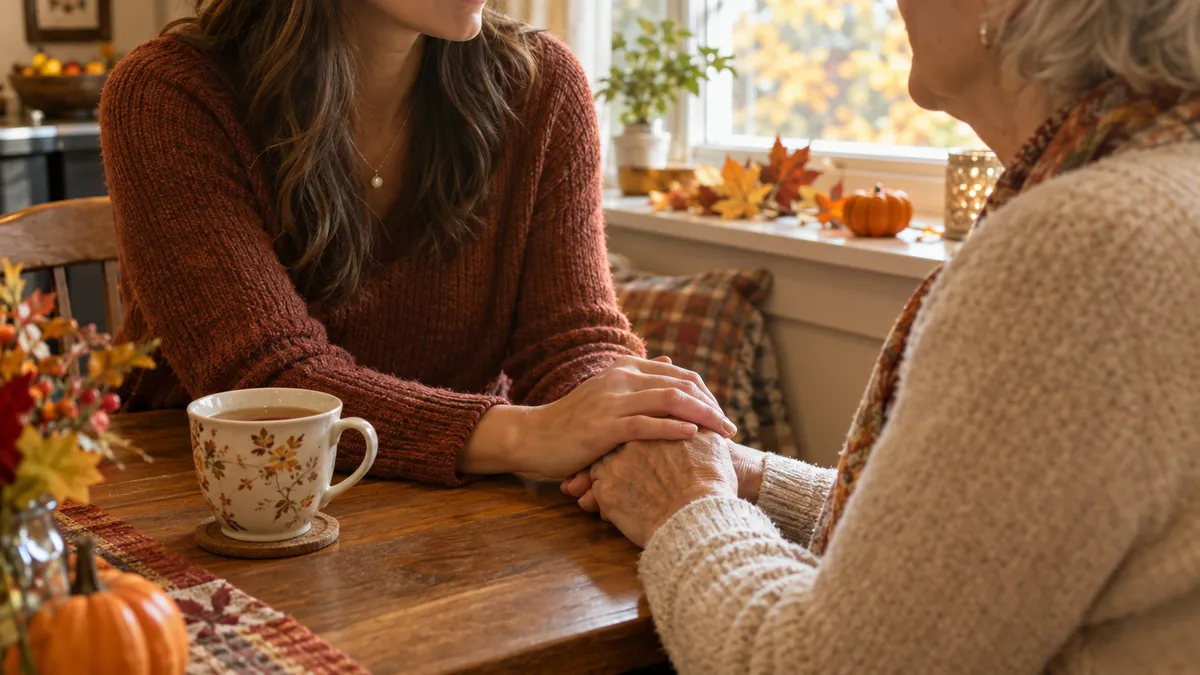 Adult daughter sharing a warm moment with her aging mother at the kitchen table during the fall season in an Upstate SC home.