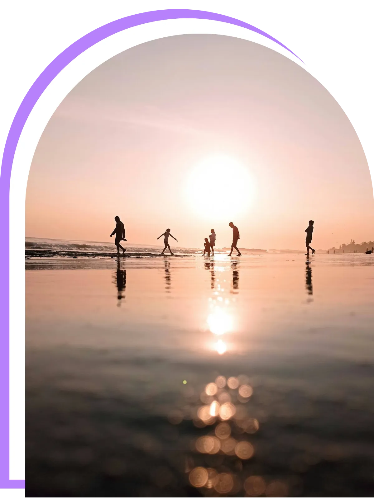 Travellers walking along a Bali beach at sunset