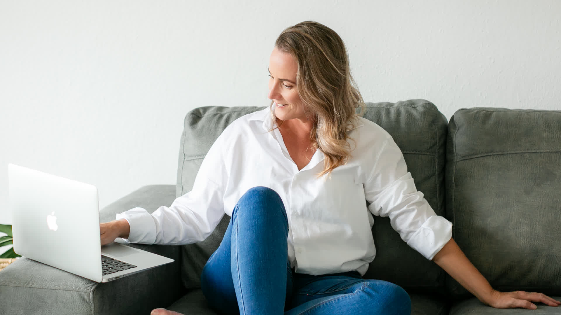 Chanelle Segerius-Bruce working on her laptop on the sofa