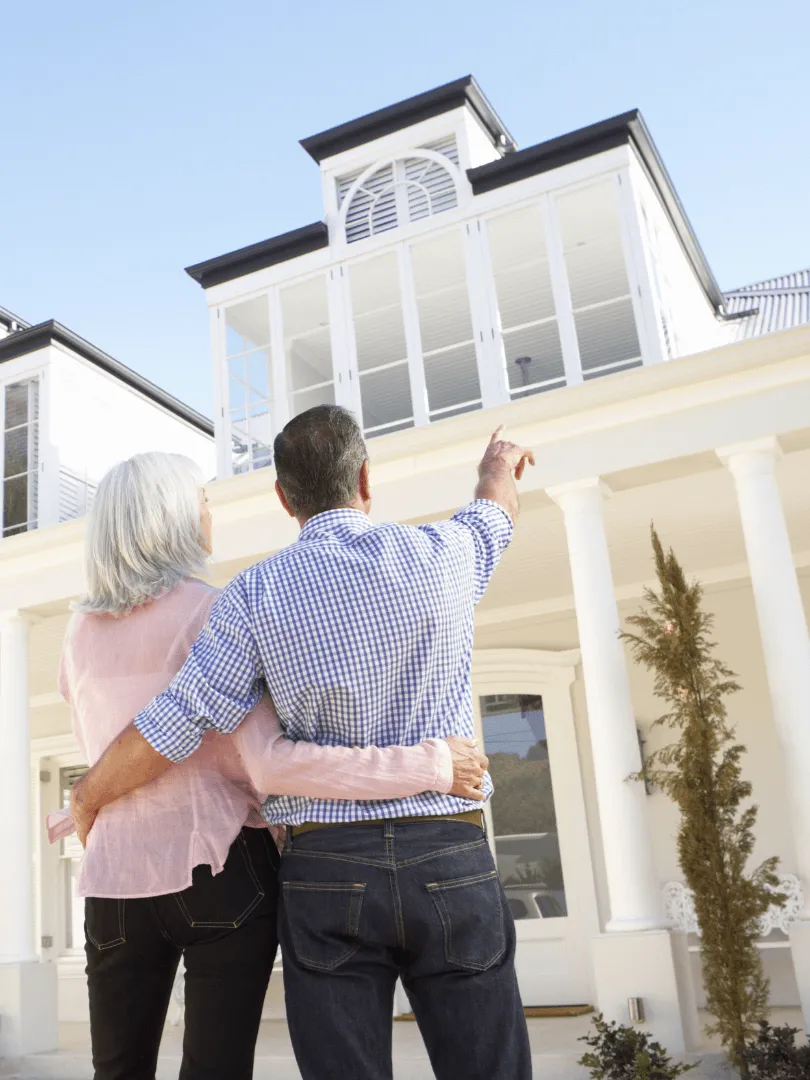 Happy homeowners admiring their newly renovated home by construction contractors in Carrollton, Texas
