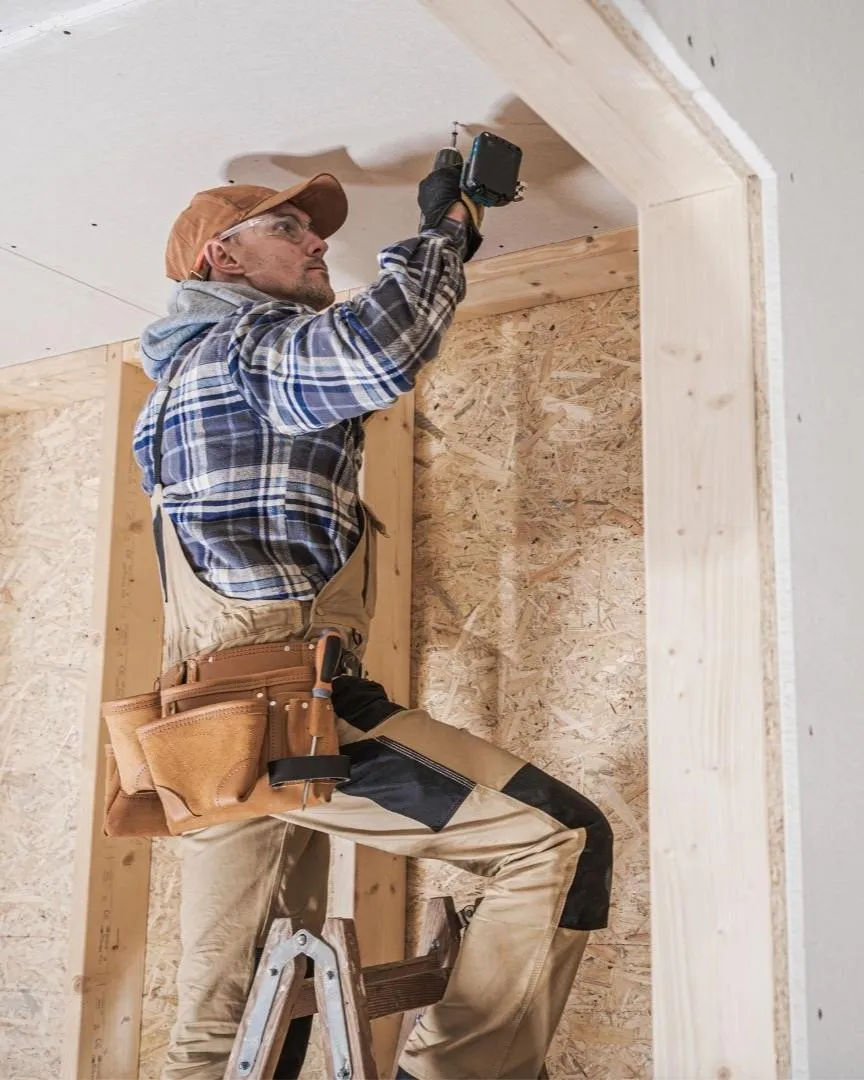 Contractor working on home remodel framing and drywall installation in Carrollton TX during a full renovation project