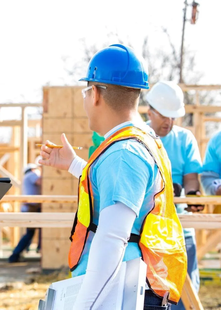 Construction worker discussing home project plans on a job site in Irving, TX