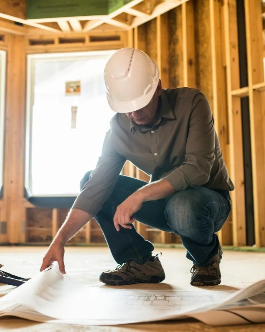General contractor reviewing home construction plans inside a Frisco, TX residential project