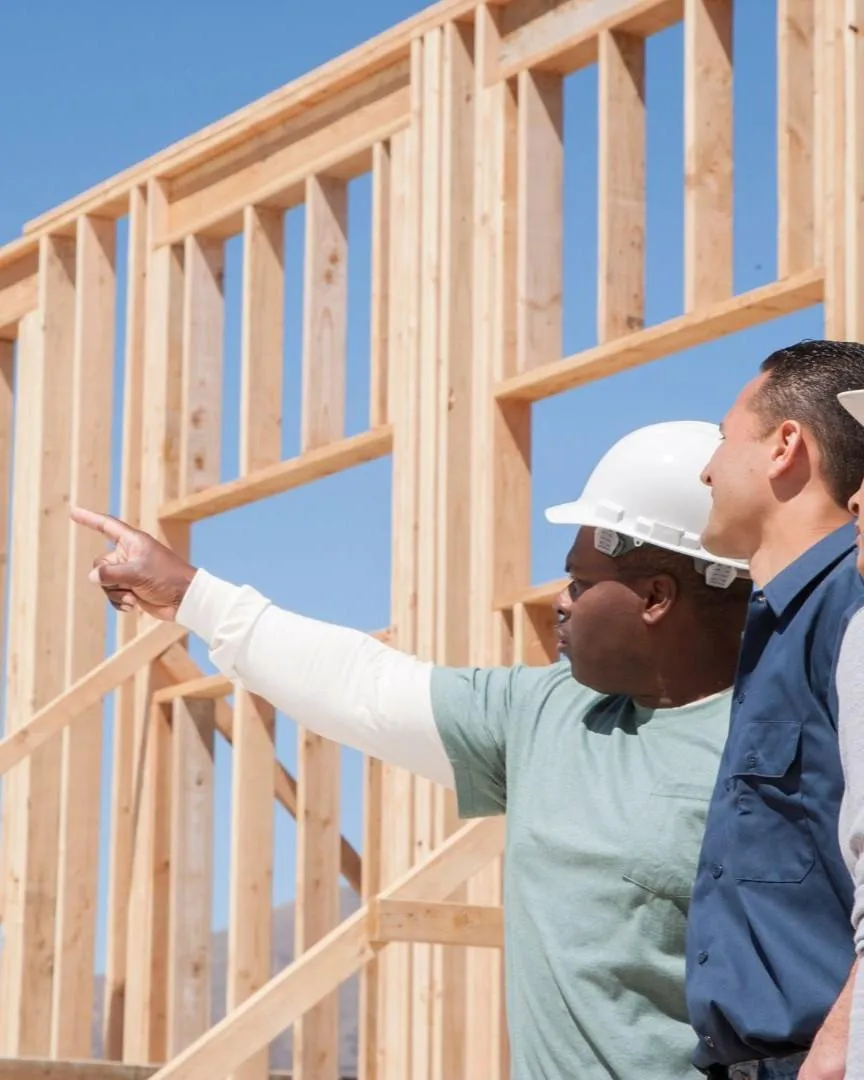 Construction team planning a home remodel project at a framing stage in Frisco, TX