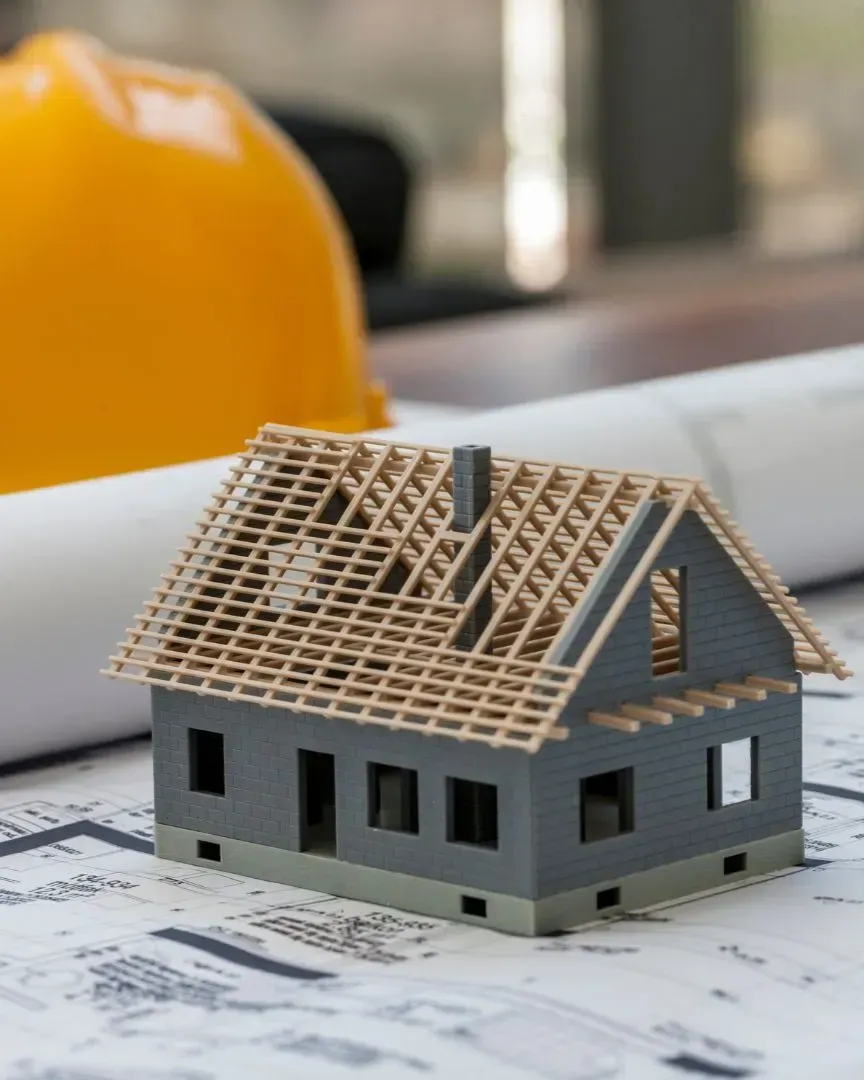 House model and construction plans representing Texas Woodpeckers general contractor promise in Flower Mound TX