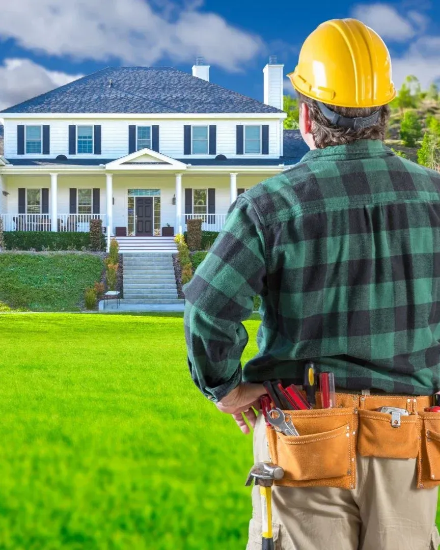 Dallas general contractor in hard hat inspecting a large home renovation project
