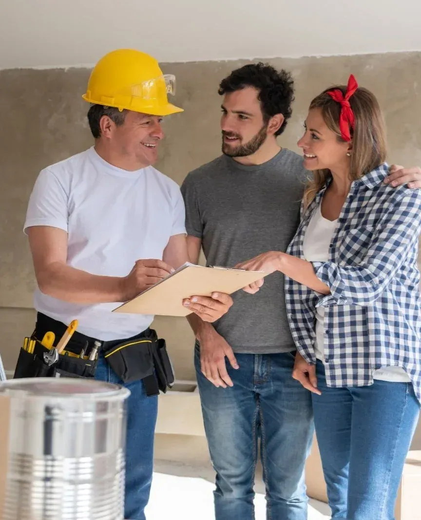 Contractor in Addison, TX discussing remodeling plans with a couple during a home renovation consultation