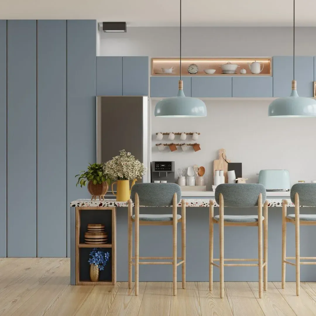 Modern blue kitchen remodel in Wylie, TX with island seating, pendant lights, terrazzo countertop, and built-in cabinets