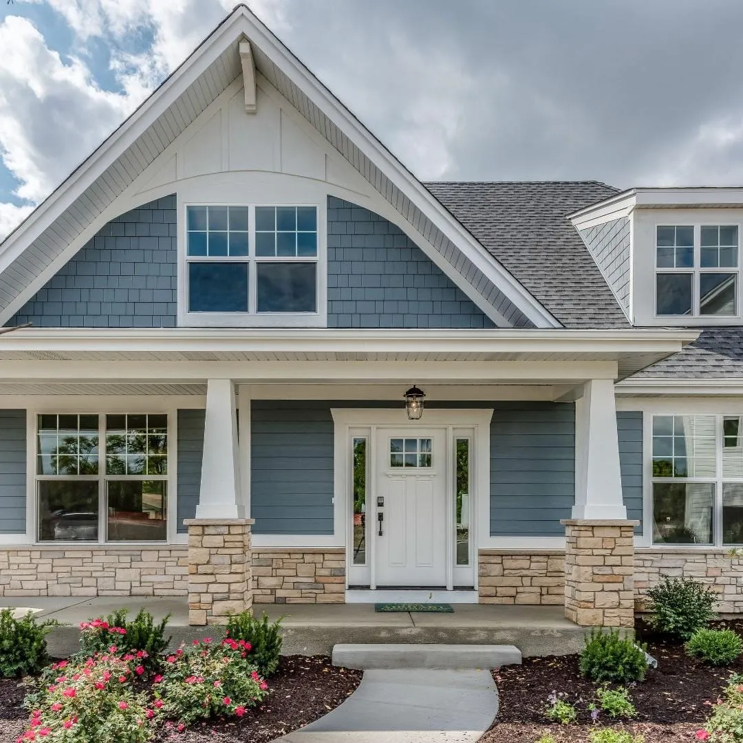 Front elevation of a Craftsman-style home with matched rooflines and siding after an addition in Farmers Branch, TX.