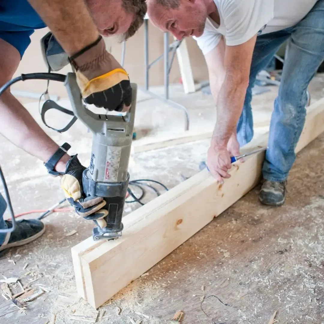 Contractors working on a home remodeling project in Lewisville TX with wood framing and power tools