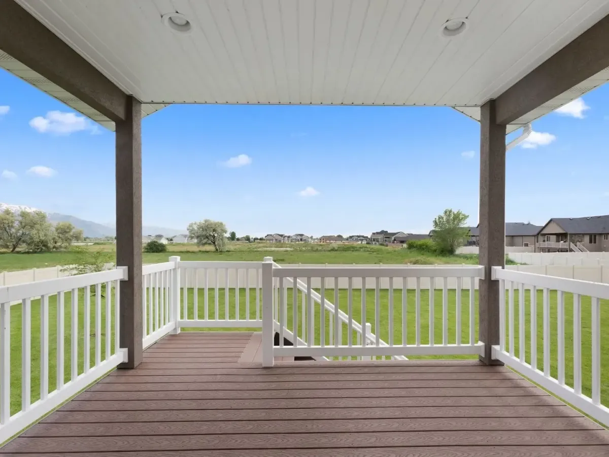 Covered patio in Lewisville TX with railing, ceiling lights, and open backyard view