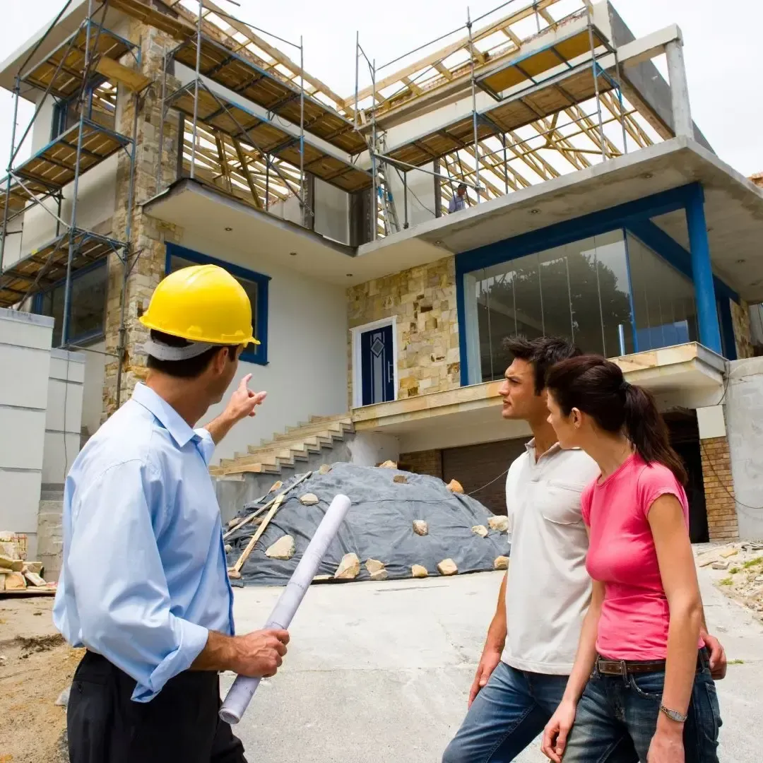Home addition construction in Frisco TX with builder reviewing plans with homeowners on site