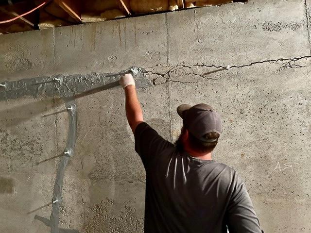A close up of a piece of cement with a crack in it
