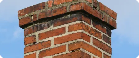 Cracked and deteriorating chimney crown.