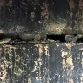 The mortar joints between these two flue tiles have fallen out, creating a gap that defeats the purpose of a chimney liner and needs to be repaired by Chimney Works.