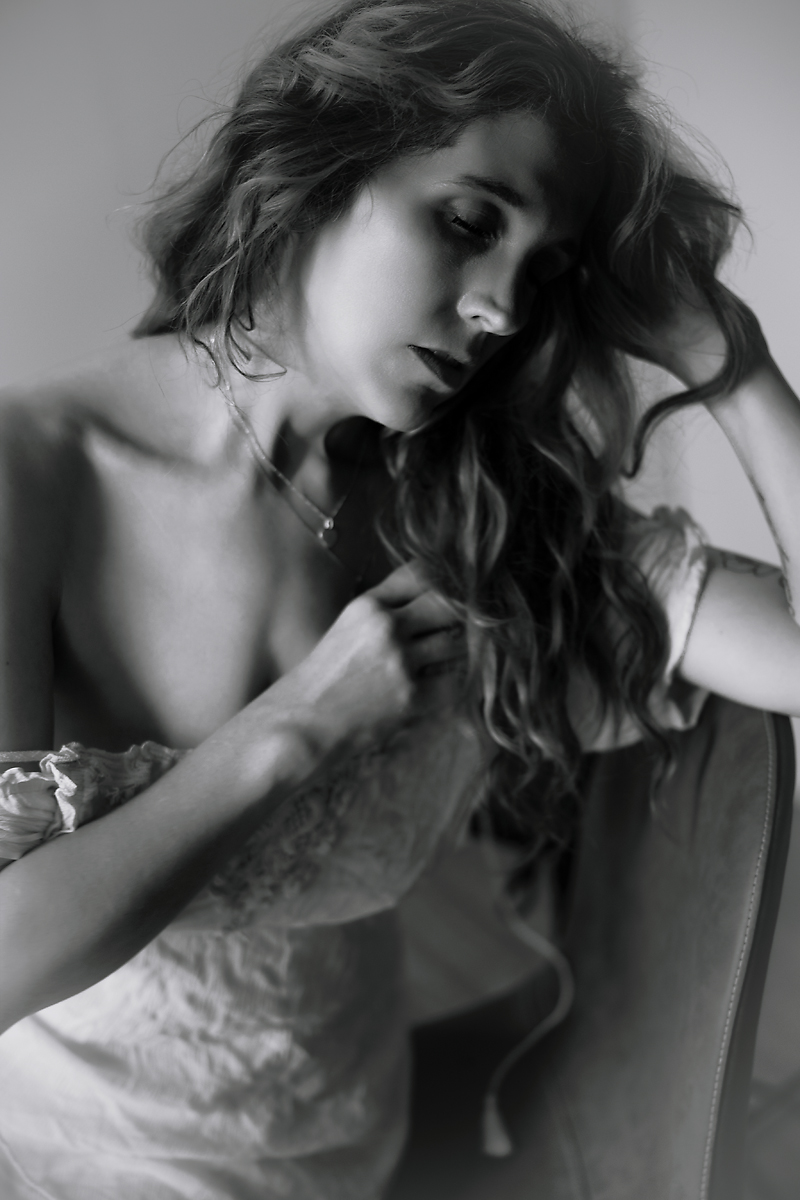 Intimate black and white editorial boudoir portrait celebrating resilience and inner strength