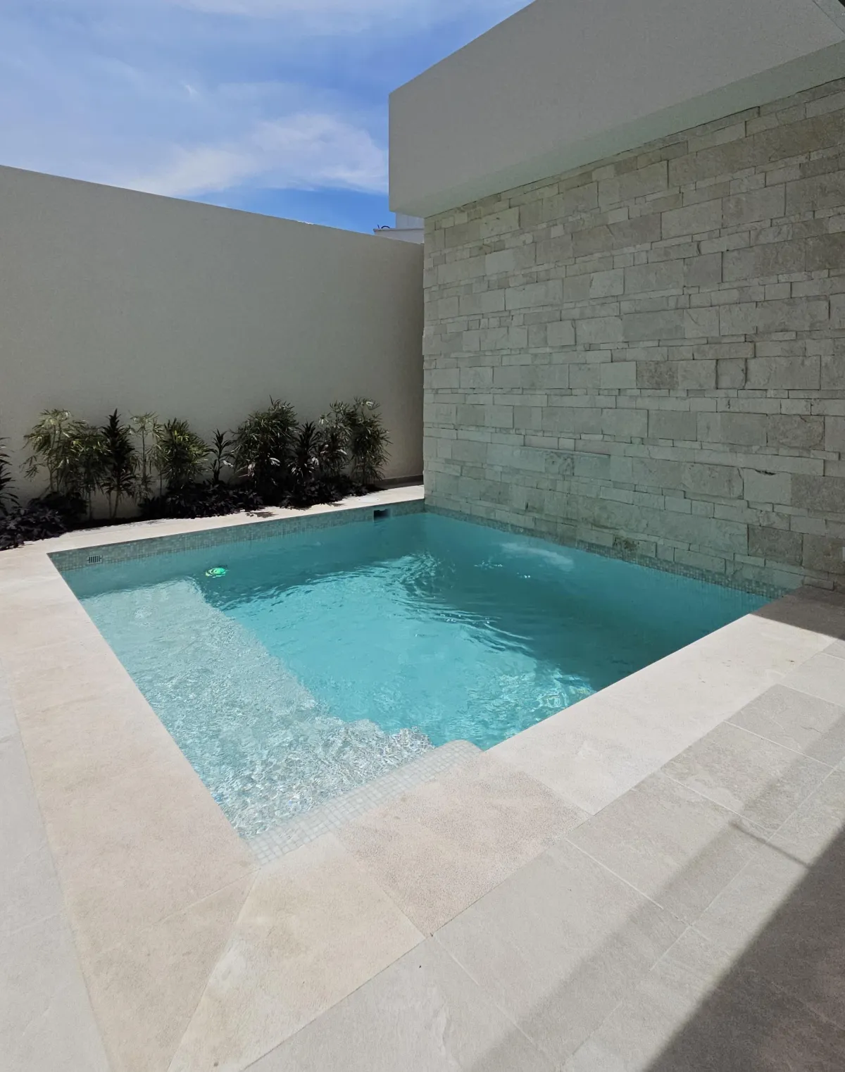 a kitchen with a sink, stove, and a window