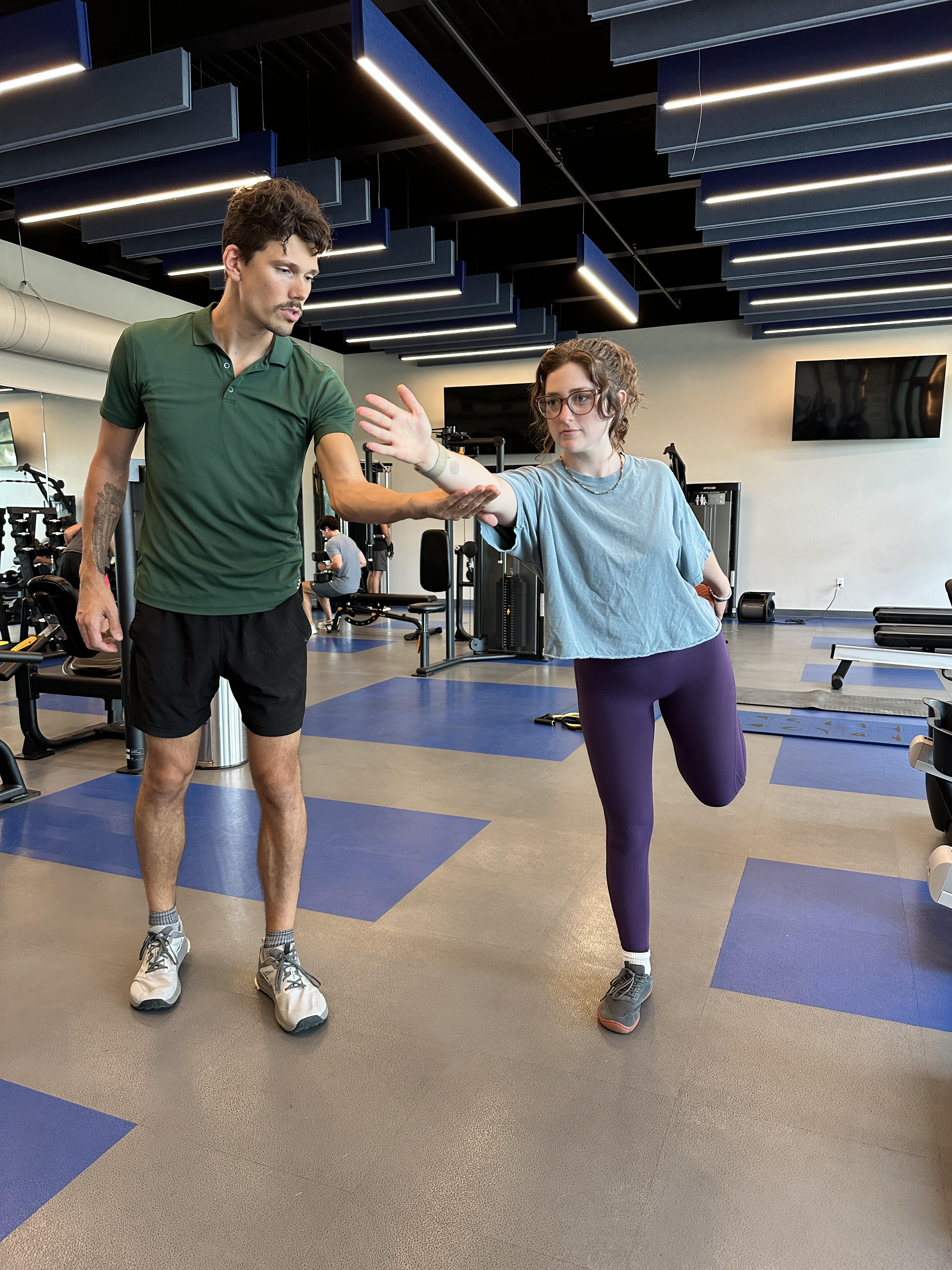 Men exercising outdoors with an ab roller wheel.