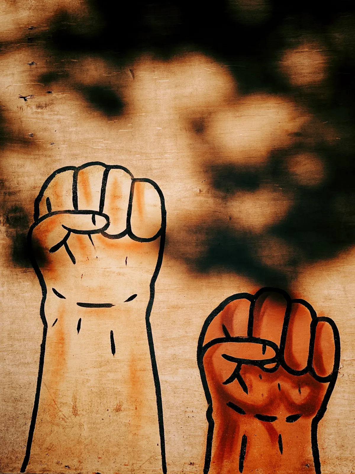 wall painting of closed fists raised in the air