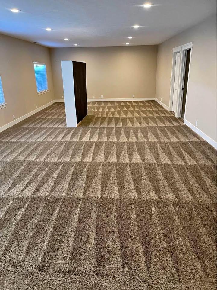 man in gray long sleeve shirt holding baby in red and white long sleeve shirt