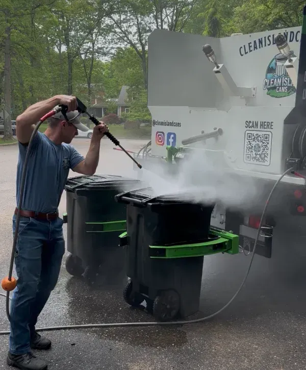 Pressure washing trash cans using eco-friendly cleaning service truck