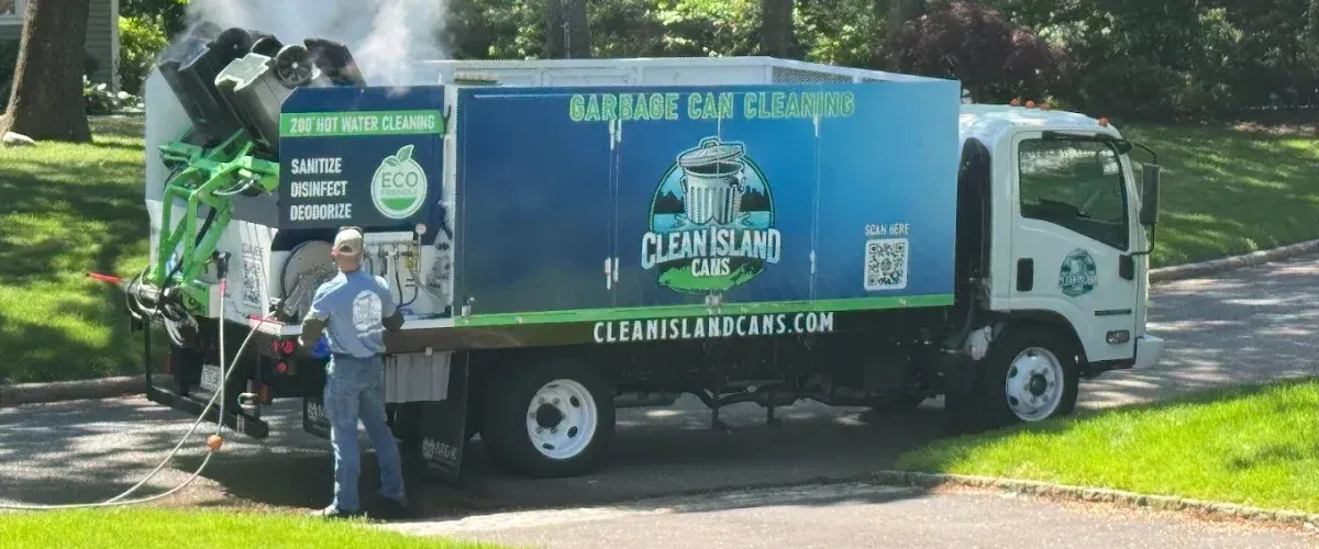 Technician performing garbage can cleaning with hot water system