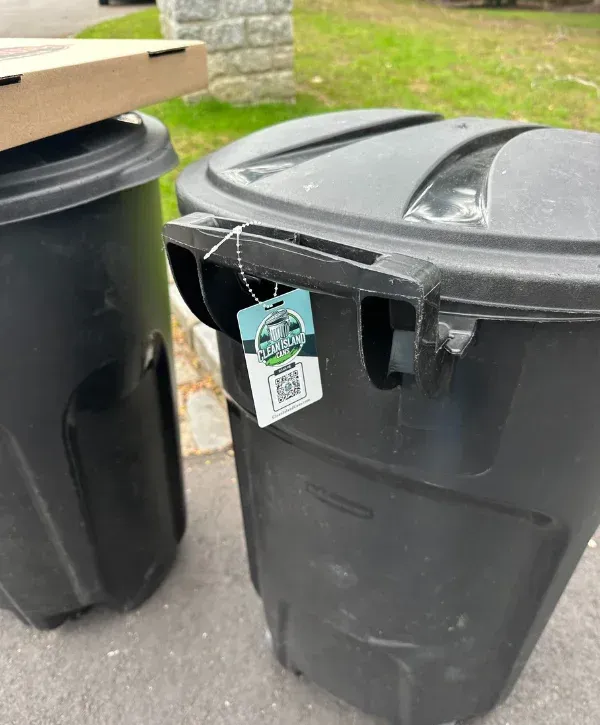 Two residential trash bins mounted on garbage can cleaning truck