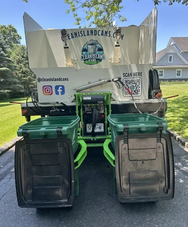 Truck mounted bin lift system cleaning garbage cans