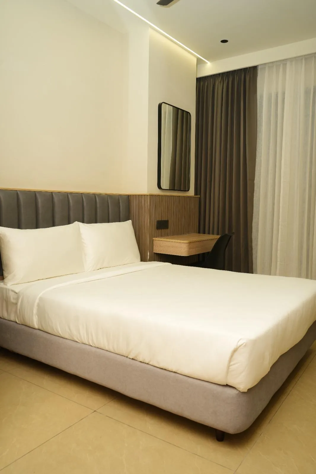 Bright, clean bedroom at APL Residency by Darling